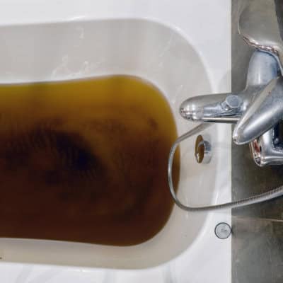 A blocked bath in need of unblocking in a house