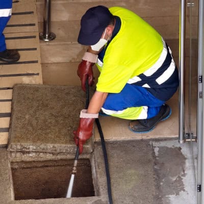 A specialist drain cleaning a blocked drain in Buxton