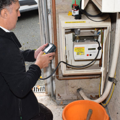 A gas safe plumber in Buxton testing a gas meter