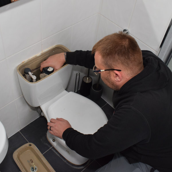 One of our Buxton plumbers repairing a toilet at a house in SK17