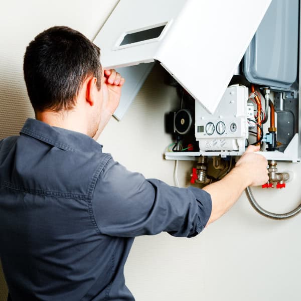 Gas Engineer Undertaking A Gas Boiler Service